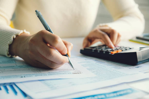 woman using calculator to do taxes